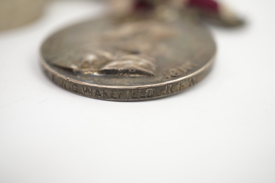 A medal group comprising of a Meritorious Service medal, a 1939 to 1945 Defence Medal, and a First World War trio awarded to 3824 SJT. F.W.G. Wakefield. R.F.A., together with a Delhi Durbar Medal 1911, crudely engraved t